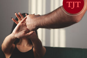 Woman raising her hands defensively as a man's fist approaches, illustrating domestic violence incidents reported in New Jersey